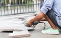 Grinder worker cuts a stone tile Royalty Free Stock Photo
