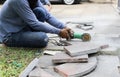 Grinder worker cuts a stone tile Royalty Free Stock Photo