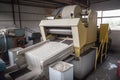 grinding machine pulverizing recycled paper into pulp for new paper products