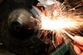 Grinding metal with a grinder in a workshop