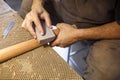 Grinding and polishing the guitar wooden neck. hand-made musical instruments