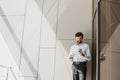 Grinning businessman is using phone during free time