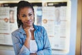 Grinning female with hand on chin in store