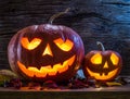 Grinning pumpkin lantern or jack-o`-lantern is one of the symbols of Halloween. Halloween attribute. Wooden background