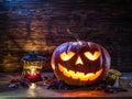 Grinning pumpkin lantern or jack-o-lantern is one of the symbols of Halloween. Halloween attribute. Wooden background