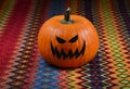 Creepy Halloween Pumpkin on a multicolored background stock images