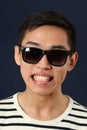 Grinning young Asian man in sunglasses Royalty Free Stock Photo