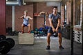 Grip this workout and rip it. two people working out with kettlebells in a gym. Royalty Free Stock Photo