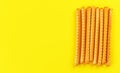 Grissini, also known as breadsticks on yellow board, view from above space for text left side Royalty Free Stock Photo