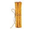 Grissini breadsticks with sesame seeds tied with string, isolated on a white