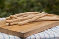 Grissini Thin Bread Sticks on wooden cutting board. Royalty Free Stock Photo