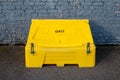 Grit bin against a brick wall Royalty Free Stock Photo