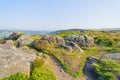 Gritstone, heather and footpaths on a hazy Baslow Edge Royalty Free Stock Photo