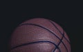 Grungy closeup of half a basketball on a black background Royalty Free Stock Photo