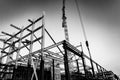 Gritty construction image of steel framing and construction crane on building site in monochrome Royalty Free Stock Photo