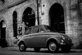 Gritty traditional back Italian street with iconic small car