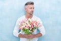 grizzle man with valentine flowers. man with valentine flowers in studio.