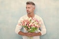 grizzle man with valentine flowers. man with valentine flowers in studio.