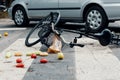 Groceries and broken bike on pedestrian crossing after collision