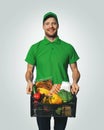 Groceries delivery - man in green uniform with food box Royalty Free Stock Photo