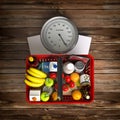 Groceries in a shopping basket on weight scale. Overnutrition, m Royalty Free Stock Photo