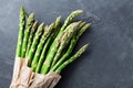 Grocery bag with bunch of fresh green asparagus on stone table top view. Healthy and diet food. Royalty Free Stock Photo