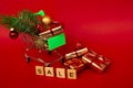 Grocery basket with golden gift boxes and Christmas balls, a sprig of Christmas tree and English letters SALE on a red
