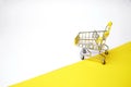 Grocery basket on wheels, minimalism. On light background.Online shopping. Grocery basket on wheels, minimalism. On