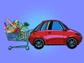 A grocery cart full of purchases near the car