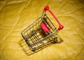 Grocery cart on a vintage yellow background