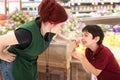 Grocery Clerk Giving Child Cherries in Store Royalty Free Stock Photo