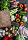 Grocery concept. Paper bag with fresh organic vegetables, fruits, turkey meat on a dark background, top view. Healthy diet food Royalty Free Stock Photo