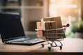 Grocery packaging boxes and a shopping bag in a shopping cart with a laptop