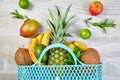 Grocery shopping bag with organic exotic fruits on white background