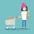 Grocery shopping concept: Young customer standing with a trolley Royalty Free Stock Photo