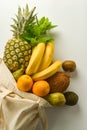 Grocery shopping with eco bag over white background. Zero waste and plastic free concept. Flat lay, top view. Copy space