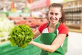 Grocery store employee showing lettuce Royalty Free Stock Photo