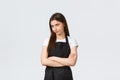 Grocery store employees, small business and coffee shops concept. Annoyed and bothered female barista smirk unsatisfied