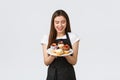 Grocery store employees, small business and coffee shops concept. Cheerful silly waitress want have bite of delicious Royalty Free Stock Photo