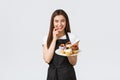 Grocery store employees, small business and coffee shops concept. Cheerful silly waitress want have bite of delicious Royalty Free Stock Photo