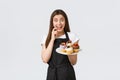 Grocery store employees, small business and coffee shops concept. Cheerful silly waitress want have bite of delicious Royalty Free Stock Photo