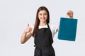 Grocery store employees, small business and coffee shops concept. Friendly cute saleswoman packing your gift or