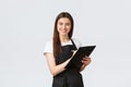 Grocery store employees, small business and coffee shops concept. Smiling friendly-looking shop manager in black apron