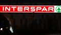 Grocery store with glowing Interspar logo sign. Shopping. Grocery supermarket