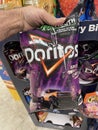 Grocery store hand holding Doritos chips