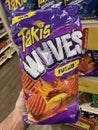 Grocery store Hand holding Taki chips fuego