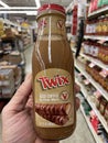 Grocery store hand holding Twix iced coffee