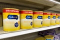Grocery store shelf with canisters of Enfamil brand baby formula