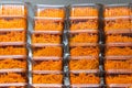 Grocery store showcase or supermarket shelf. Transparent plastic containers with Korean carrots