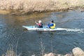 GRODNO, BELARUS - APRIL, 2019: kayak freestyle competition on fast cold water river strenuously rowing, spirit of victory